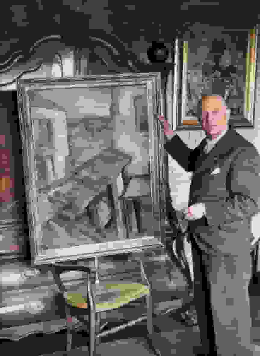 Piet Boendermaker met een schilderij van Piet Wiegman